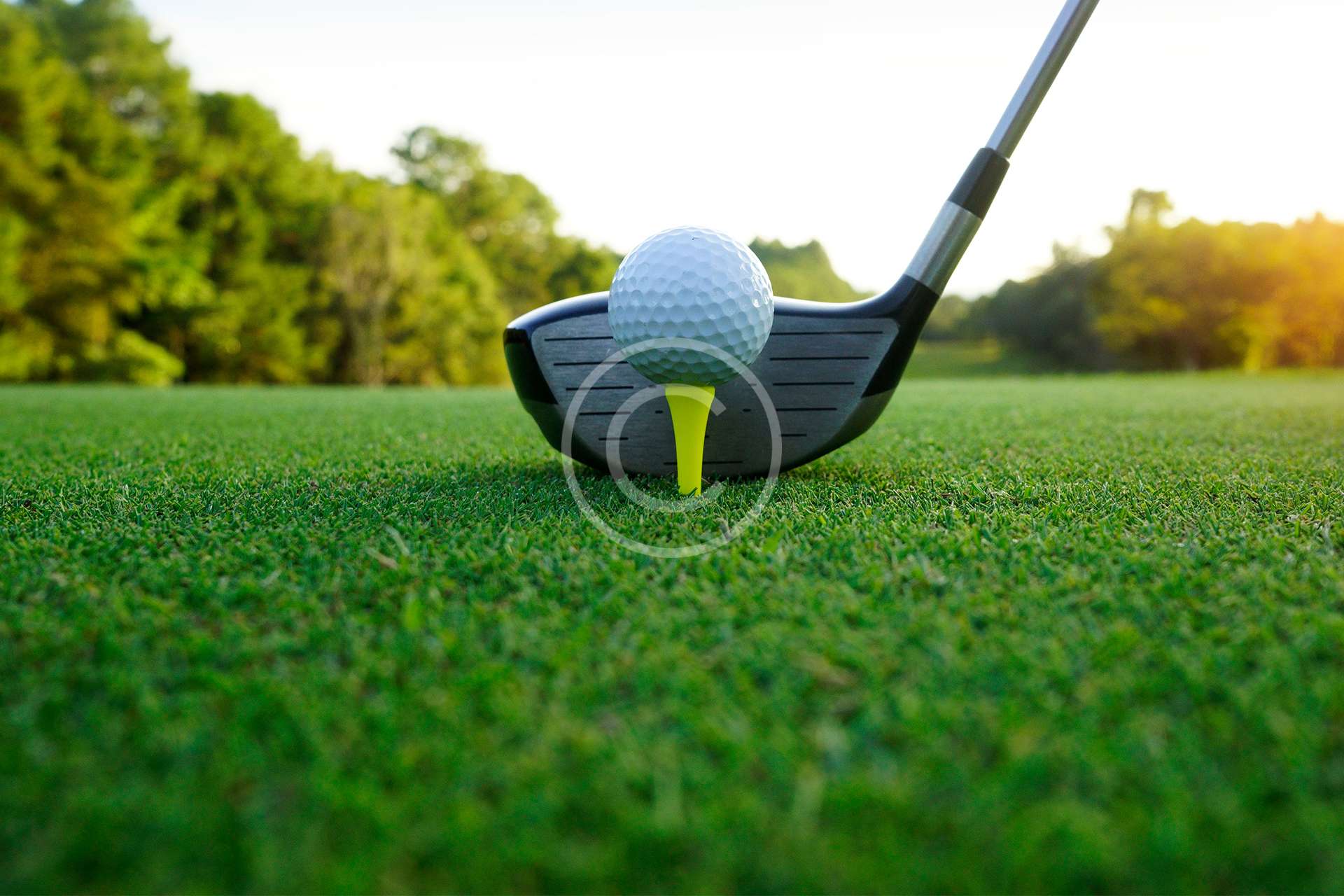 Golf ball and golf club in beautiful golf course at sunset background.